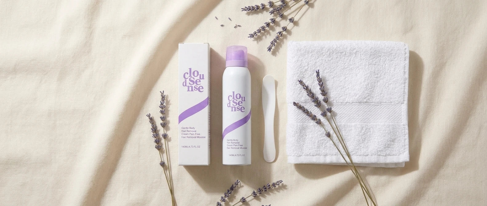 CloudSense Gentle Hair Removal Mousse box, can, and applicator styled with fresh lavender and a towel